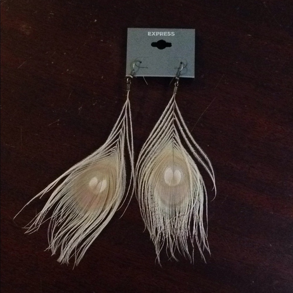 Express white peacock feather earrings.